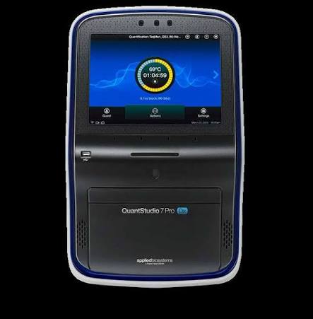 A BD QuantStudio 7 Pro DX rtPCR instrument with a black body and blue trim, featuring a large touchscreen displaying a user interface and a circular timer.